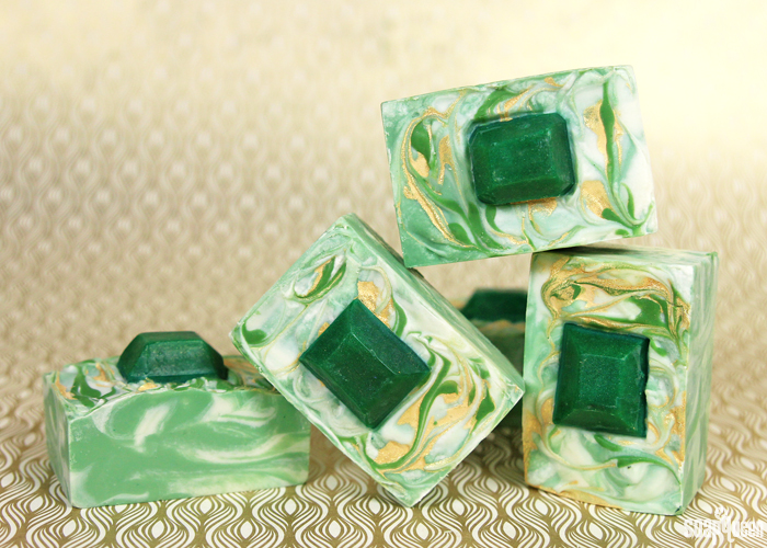 This Emerald Swirl Cold Process Soap Tutorial uses melt and pour embeds and mica painting to create a sophisticated and eye-catching design. 