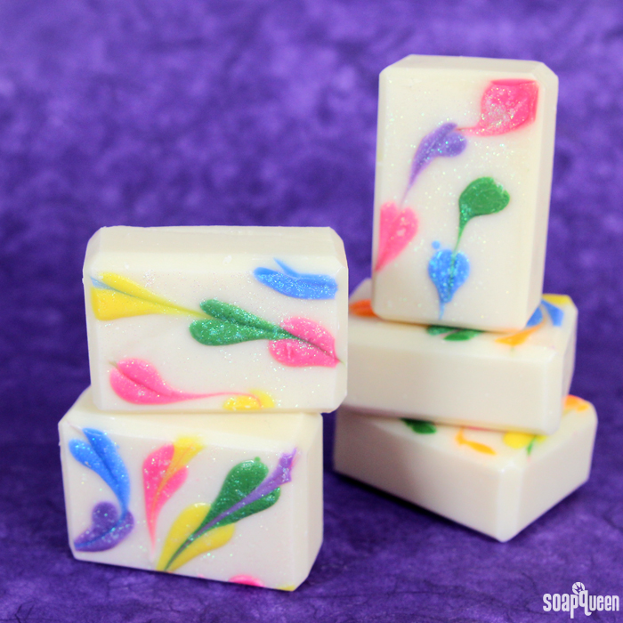 This Rainbow Heart Swirl Cold Process Soap features lots of color, glitter and smells like a tropical vacation!
