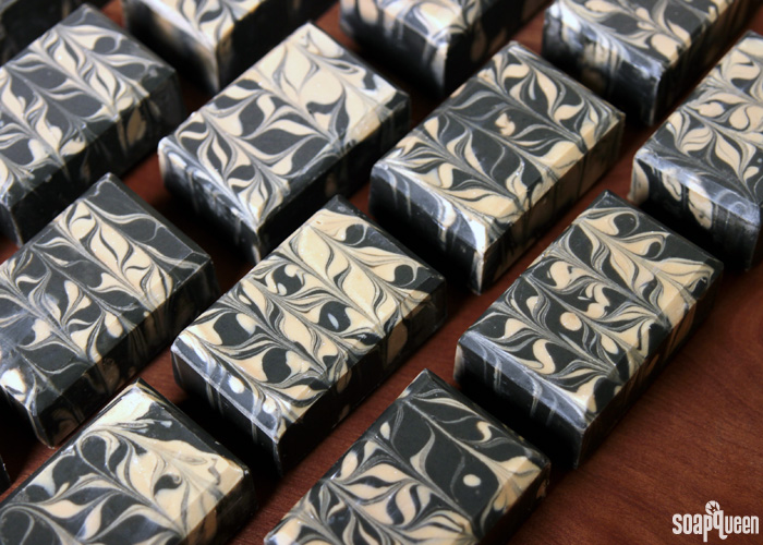 Learn how to make this Charcoal & Cedar Beer Cold Process Soap. It's scented with a natural blend of essential oils, and uses all natural colorants to create a beautiful contrasting swirl.