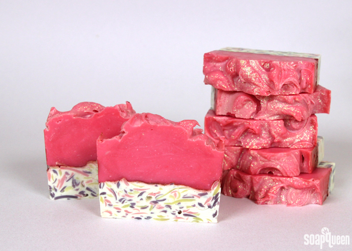 This cold process soap features a hot pink color palette, lots of glitter and a confetti layer to create an eye catching bar. 