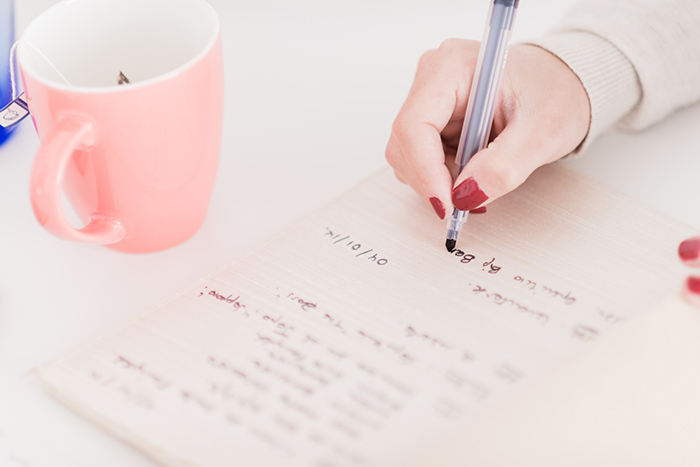 She is writting some notes.